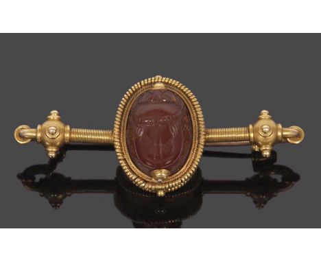 An archeological revival scarab brooch, the oval hardstone scarab with intaglio figure to reverse, in a deep collet mount wit