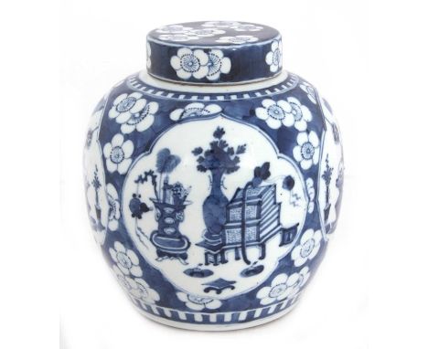 A 19th Century Chinese porcelain jar and cover with prunus decoration, well painted with panes of precious objects in Kangxi 