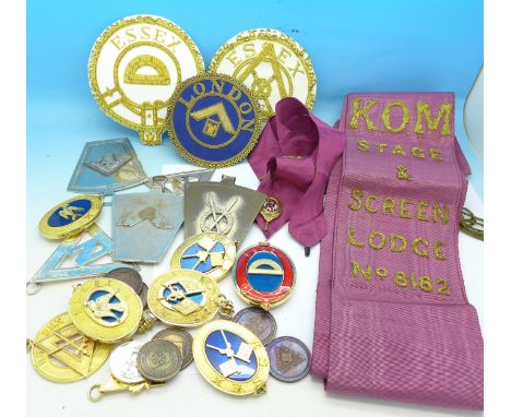 A collection of Masonic medallions, badges, purple sash, etc.