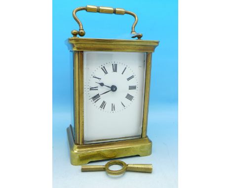 A brass and four glass sided carriage clock with key
