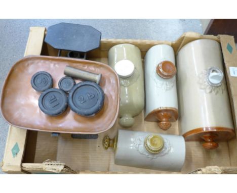 Four stoneware hot water bottles and a set of balance scales with weights, and a small brass container