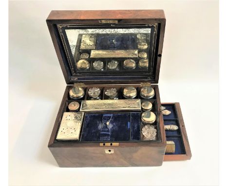 VICTORIAN BURR WALNUT TRAVELLING VANITY CASEwith mother of pearl cartouch to the cover and escutcheon, the interior cover wit