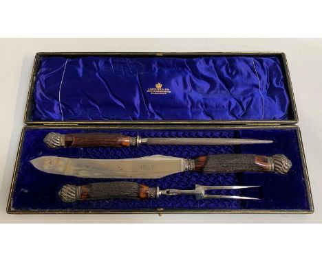 LATE VICTORIAN HORN HANDLED CARVING SETcomprising knife, fork and steel, the knife marked J. Cameron & Son Silversmiths Kilma