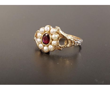 GARNET AND SEED PEARL CLUSTER RINGthe central oval cut garnet in ten pearl surround, flanked by pierced entwined snake decora