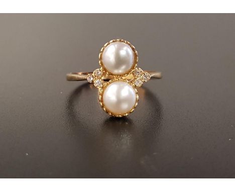 UNUSUAL PEARL AND DIAMOND RINGthe two vertically set cultured pearls flanked by three small diamonds to each shoulder, on nin