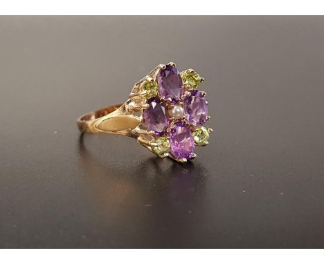 UNUSUAL 'SUFFRAGETTE' RINGthe oval cut amethysts and round cut peridots around a central seed pearl representing the colours 