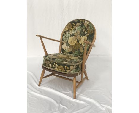 ERCOL BEECH ARM CHAIRwith a shaped stick back and arms above a solid seat, with a floral covered back and seat cushion, stand