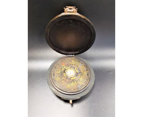 CHINESE FENG SHUI LOOPAN/COMPASSwith a central compass surrounded by a metal disc with Chinese characters, contained in a cir