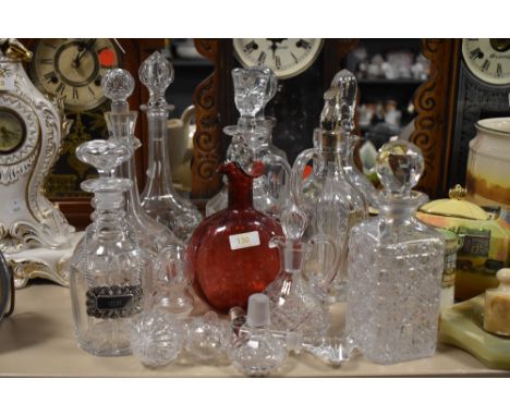 A large collection of vintage decanters, stoppers and similar.