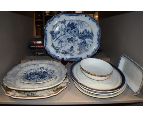 A selection of vintage and antique platters including blue and white ware.