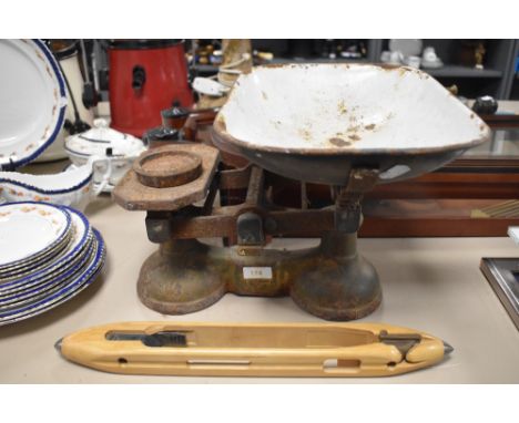 A set of vintage scales and a wooden shuttle.