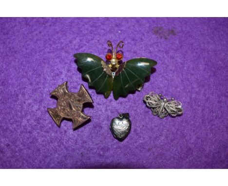 A small selection of jewellery including a British Columbian jade brooch in the form of a butterfly, a rolled gold cross broo