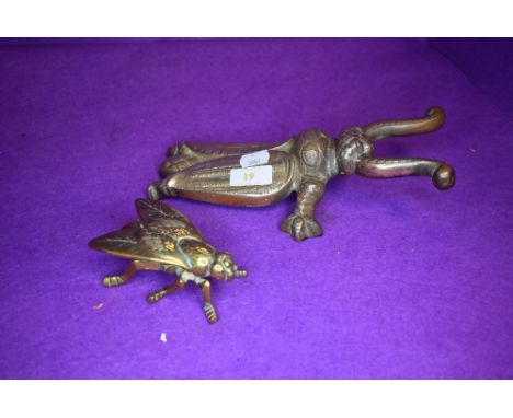 A vintage cast iron boot pull in the form of a beetle and a similar brass wasp box