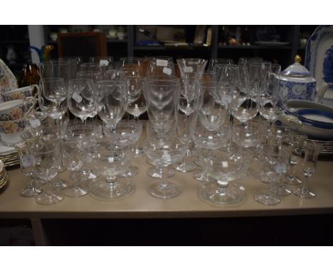 A mixture of wine glasses, vintage etched champagne glasses and unusual sherry glasses having twist and dimple design.