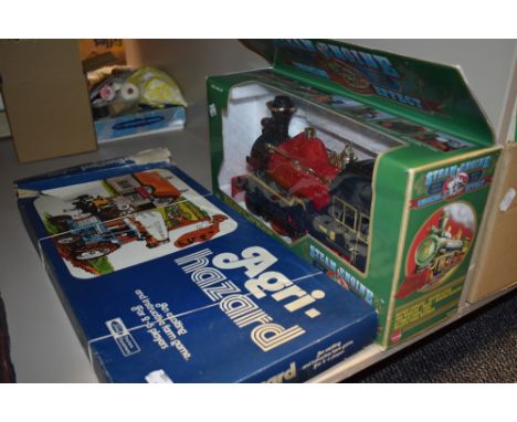 A vintage Agri hazard board game and A boxed steam engine toy.