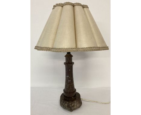 An early 20th century Cornish serpentine lighthouse shaped table lamp with original period shade.  Approx. 47cm tall (to top 
