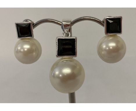 A pearl and black spinel pendant with matching earrings. Bale of pendant marked 925. Pendant approx. 3cm drop, stud earrings 