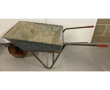 A vintage galvanised wheel barrow with 'Ironcrete' marked handle grips.  
