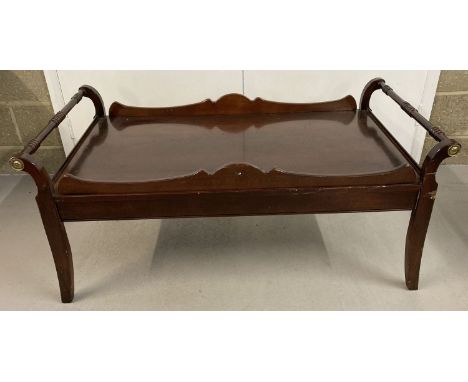 A large vintage dark wood coffee table with galleried top and turned handle design.  Approx. 54cm tall x 124cm long