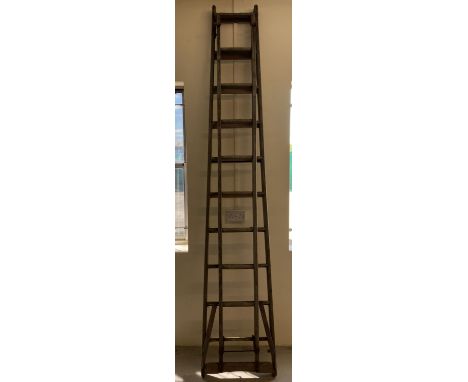 A large vintage wooden extending ladder from The Patent Safety Ladder Company.  Approx. 264cm long unextended.
