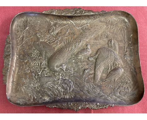 A vintage metal tray featuring Oriental birds, in relief. With floral shaped handles.  Approx. 29cm x 22cm.