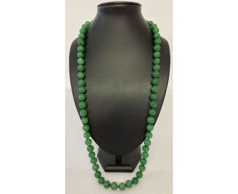 A 31" apple green jade, beaded necklace; knotted between each bead.  Beads approx. 1.25cm diameter.