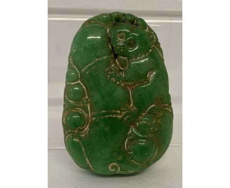 A carved Chinese green jade pendant.  Approx. 5.5cm x 3.75cm.