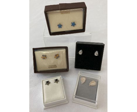 5 pairs of silver and white metal stud style earrings. Comprising: Blue enamel stars, leaf design, stars set with black onyx,