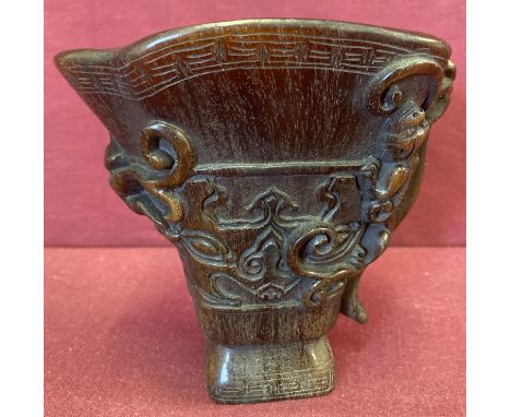 A Chinese carved libation cup with mythical creature detail.  Approx. 12.5cm tall.