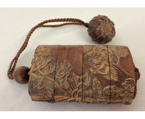 A Chinese carved hardwood Inro; stacking snuff/spice box. With floral detail to each side and carved flower head shaped penda