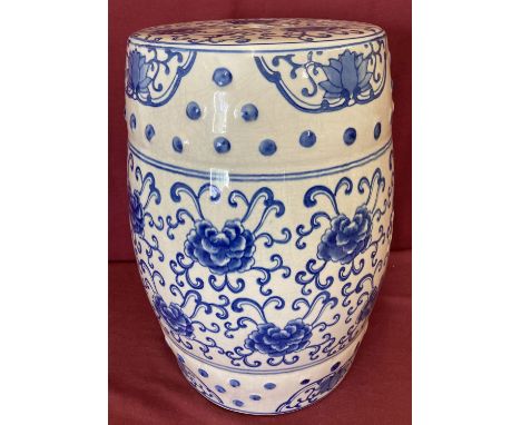 A large Chinese ceramic blue and white hand painted stool. With floral decoration and cut out detail to seat. Approx. 45cm ta