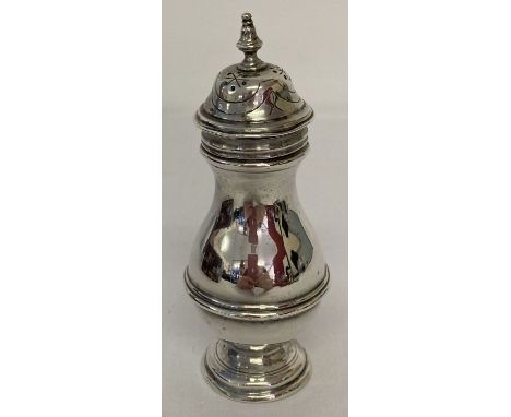 A vintage silver pepperette with turned finial design and engraved detail to lid. Fully hallmarked London 1919 and with maker