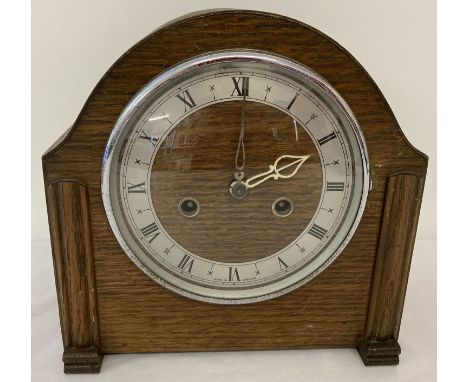 A vintage dark wood cased chiming mantle clock with Enfield movement. Complete with pendulum. 