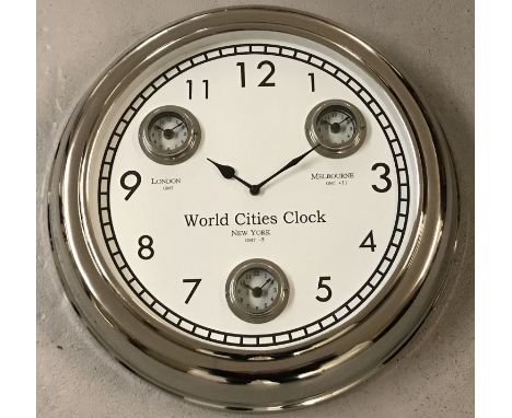 A large modern wall hanging, multi dial, world cities, clock with chrome finish. Showing dials for the time in London, Melbou