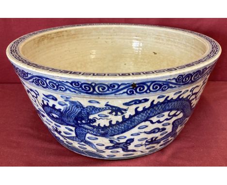 A large Chinese blue and white hand painted bowl/planter with dragon detail to outer bowl.  Approx. 21.5cm tall x 46.5cm diam