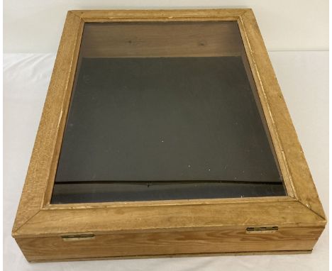 A light wood table top display case with faux leather to interior. Slope toppped with glass panelled hinged lid. Approx. 61cm