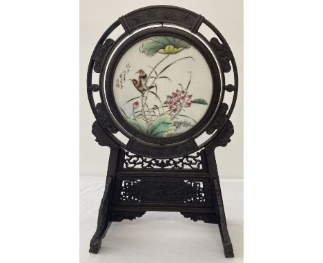 A dark wood framed Chinese ceramic rotating porcelain panel. Signed floral and bird detail to circular panel. Decorative pier