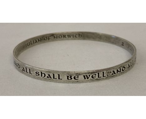 A silver bangle with engraved inscription by Julian of Norwich. "All shall be well, and all shall be well, and all manner of 