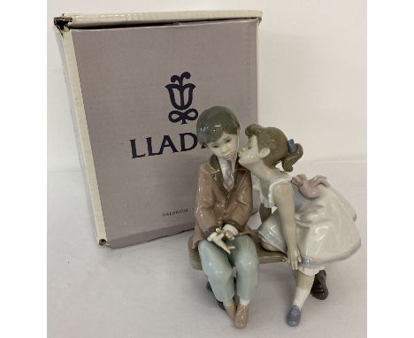 "Ten And Growing" figurine of a boy and girl by Lladro. Complete with original box.  Approx. 17.5cm tall.