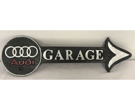 A black, silver and red painted Audi Garage arrow wall hanging sign.  Approx. 41cm long.