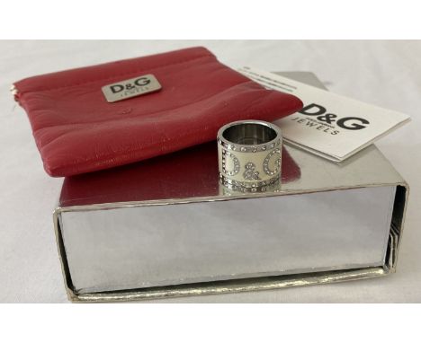 A Dolce &amp; Gabbana band style dress ring with original box, red leather effect pouch. Complete with Coa/care instructions.