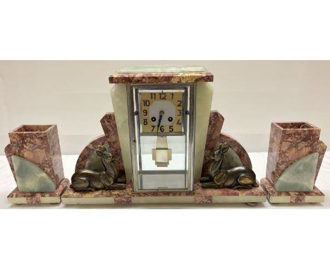 An Art Deco marble, onyx and spelter mantel clock garniture. Period design wind up chiming clock, complete with key and pendu
