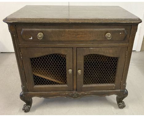 A dark oak vintage 2 door cabinet with single drawer and cabriole style legs. 2 sectional interior cupboard, with one half ho