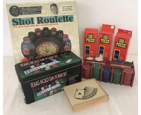 A Texas Hold 'Em Poker Set (mat missing) together with 3 sets of extra poker chips. And a Gentlemen's club Shot Roulette game