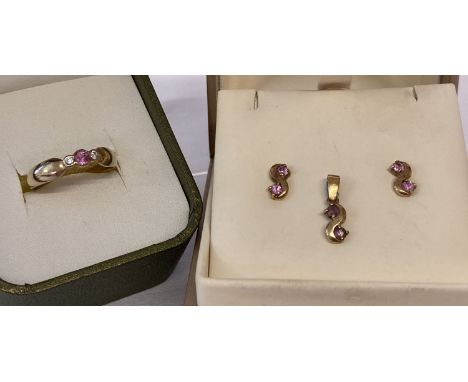 A 9ct gold diamond and pink sapphire matching dress ring, earrings and pendant. Central round pink sapphire ring with 2 small