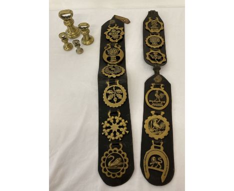 A collection of 12 horse brasses on leather straps together with 4 vintage bell weights. Weights comprise: 2lb, 1lb, 8oz and 