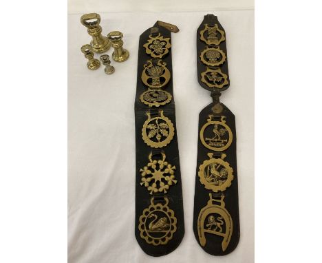 A collection of 12 horse brasses on leather straps together with 4 vintage bell weights. Weights comprise: 2lb, 1lb, 8oz and 