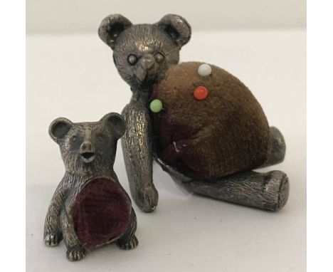 Two vintage pewter teddy bear pin cushion's.  Largest approx. 4cm tall.