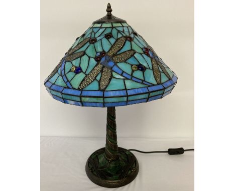 A tiffany style table lamp with leaded glass shade and lamp base. Dragonfly detail to shade and base. Approx. 58cm tall.