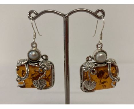 A pair of silver mounted Art Nouveau style drop earrings set with amber and pearl.  Approx. 4cm total drop x 2cm width.